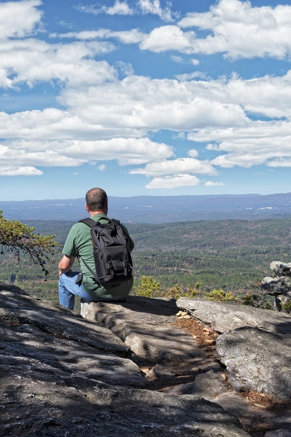Hiker taking a break to look at the view in Cheaha State Park in Alabama