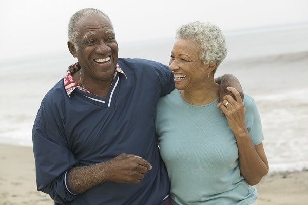 Senior couple walking along Gulf Coast beach after LASIK surgery